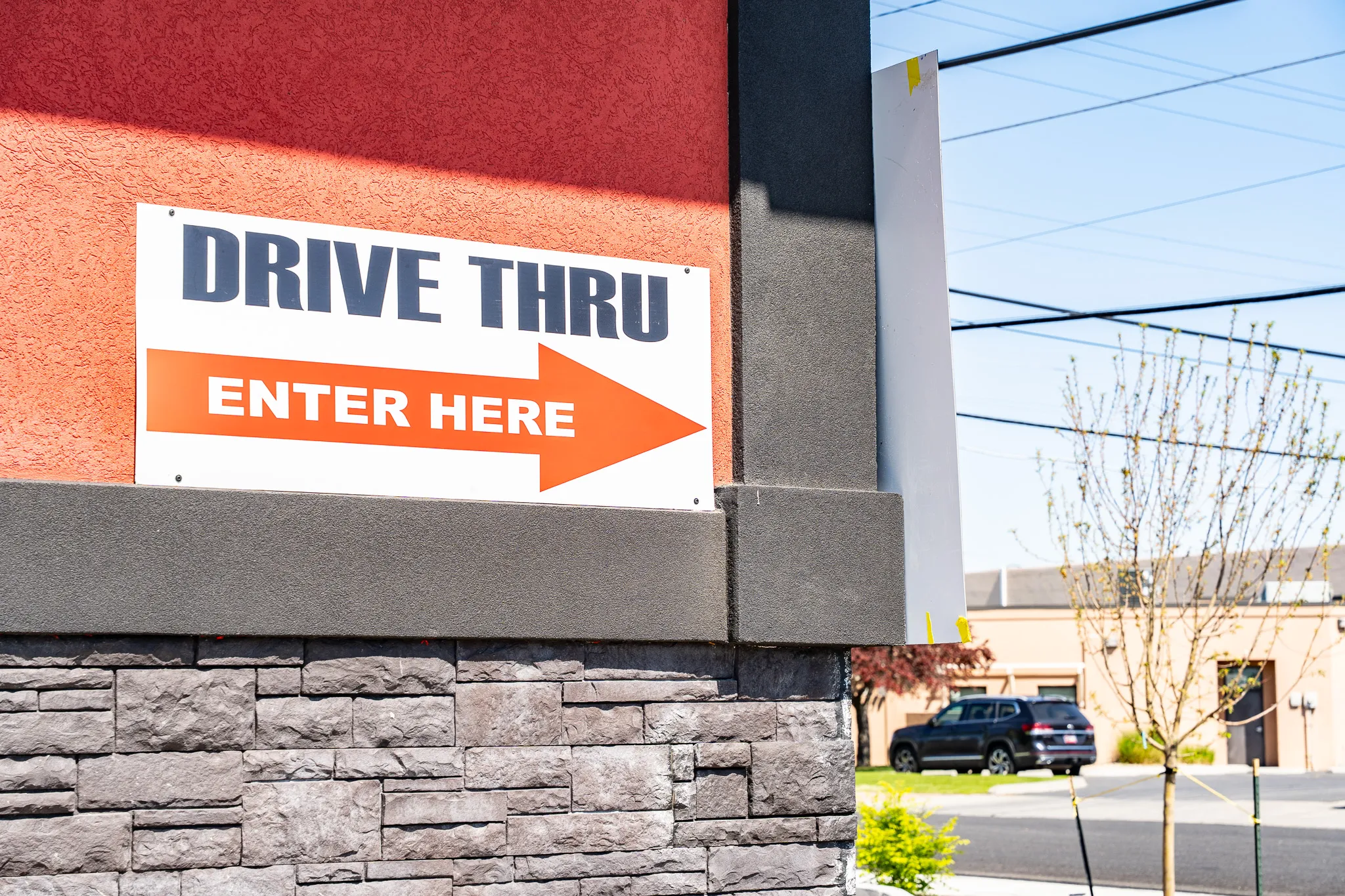Carnicería La Buena "Drive Thru — Enter Here" sign at the market entrance