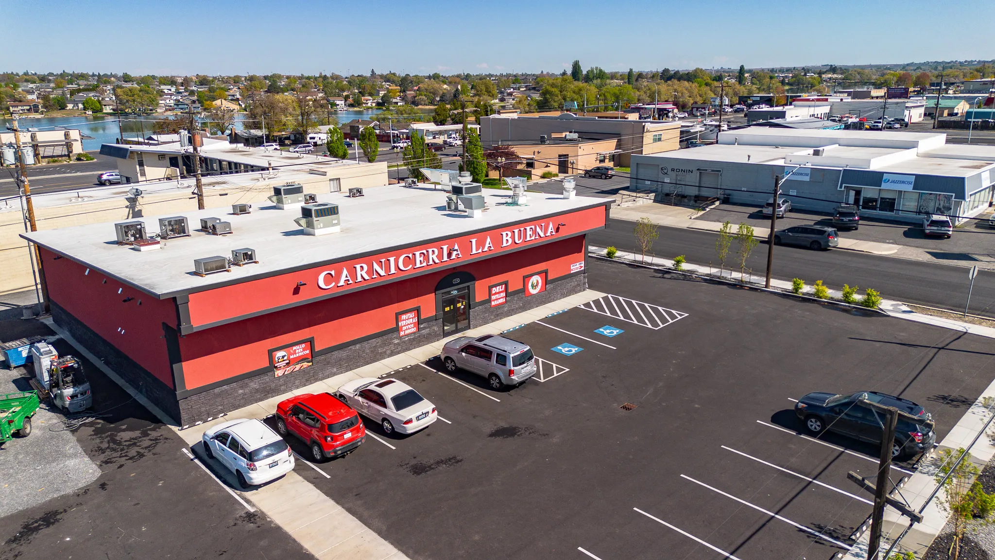 Aerial view of the Carnicería La Buena market building and parking lot in Moses Lake, Washington